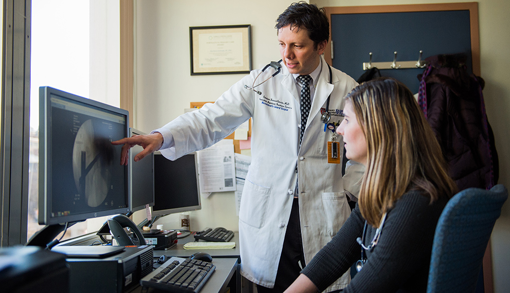 Healthcare providers looking at a computer screen. Healthcare providers looking at a computer screen.